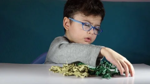 Five year old boy playing with toy soldiers Stock Footage 82489680