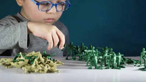 Five year old boy playing with toy soldiers Stock Footage 82489705