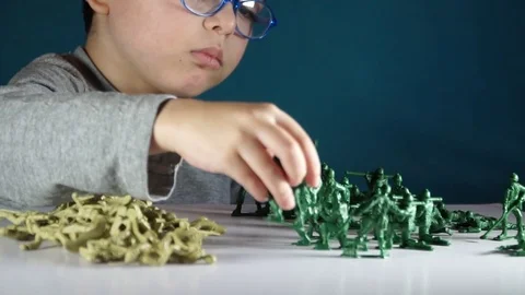 Five year old boy playing with toy soldiers Stock-Footage 82489730