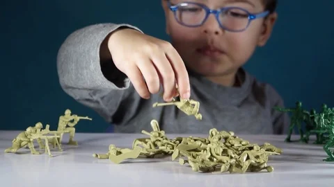 Five year old boy playing with toy soldiers Stock-Footage 82489749