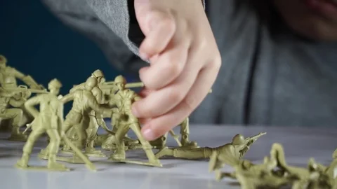 Five year old boy playing with toy soldiers Stock-Footage 82489812