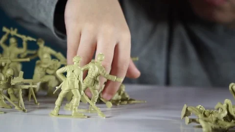 Five year old boy playing with toy soldiers Stock-Footage 82489821