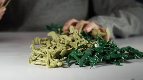 Five year old boy playing with toy soldiers Stock-Footage 82489839