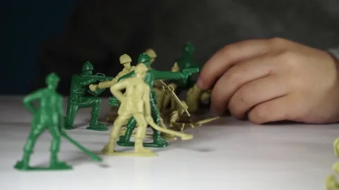 Five year old boy playing with toy soldiers Stock-Footage 82489857