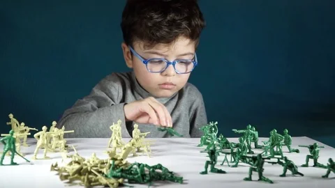 Five year old boy playing with toy soldiers Stock-Footage 82489892