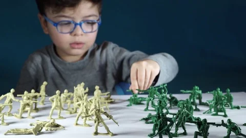 Five year old boy playing with toy soldiers Stock-Footage 82489949