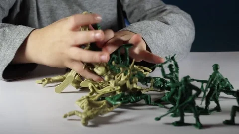 Five year old boy playing with toy soldiers Stock-Footage 82490199
