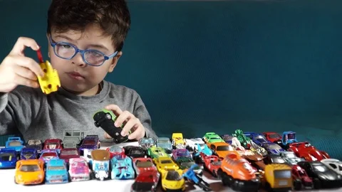 Five year old boy playing with toy cars Stock-Footage 82490347