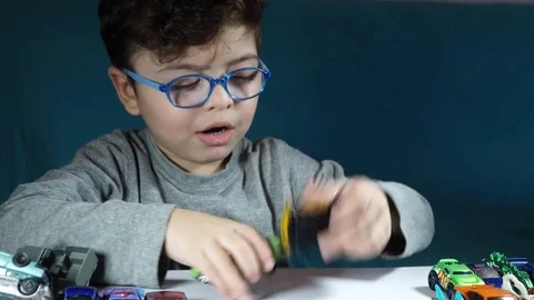 Five year old boy playing with toy cars Stock-Footage 82490496