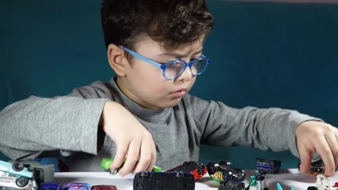 Five year old boy playing with toy cars Stock-Footage 82490519