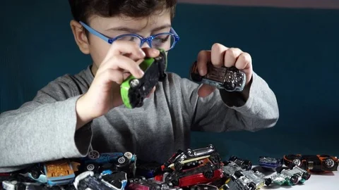 Five year old boy playing with toy cars Stock Footage 82490562