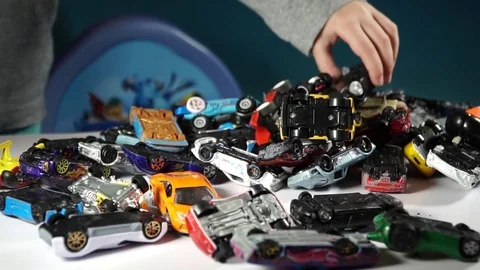 Five year old boy playing with toy cars Stock Footage 82490585