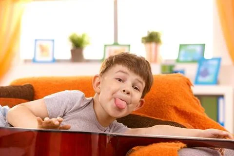 Five year old boy putting out tongue for pose Five year old happy boy putt... 스톡 사진