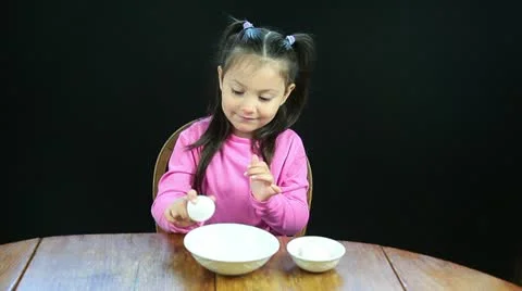 Five year old girl cracking eggs Stock Footage 11037401