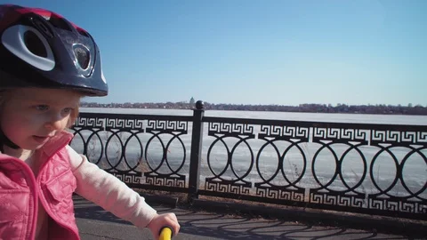 Five-year-old little blonde girl riding bike in an old park. Stock Footage 106447670