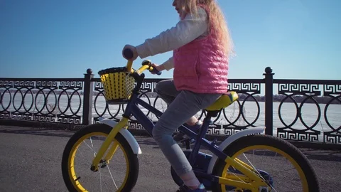 Five-year-old little blonde girl riding bike in an old park. Stock Footage 106447963