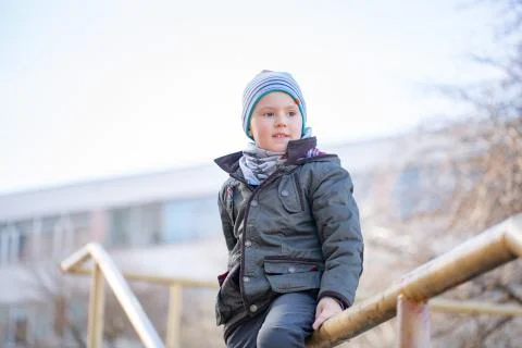 Five years old boy in cap smiling in autumn scenery Stock Photos