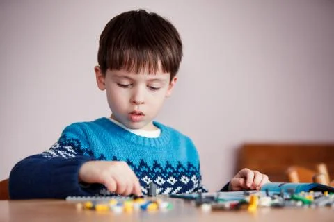 Five years old boy playing with building blocks Stock Photos