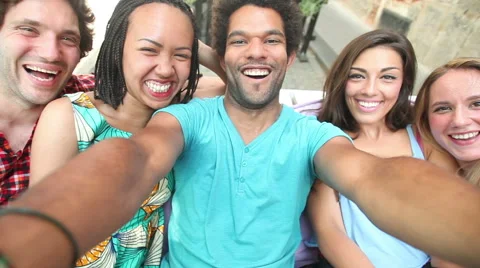 Five young adults laughing while taking a group selfie Stock Footage 59566486