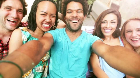 Five young adults laughing while taking a group selfie Stock Footage 59566843