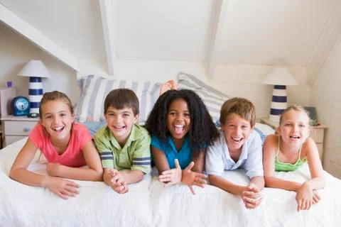 Five Young Friends Lying Down Next To Each Other Stock Photos