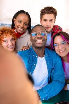 Five young multiracial friends taking a selfie portrait together outdoors Stock Photos