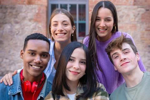 Five young multiracial friends taking a selfie portrait together outdoors Stock Photos