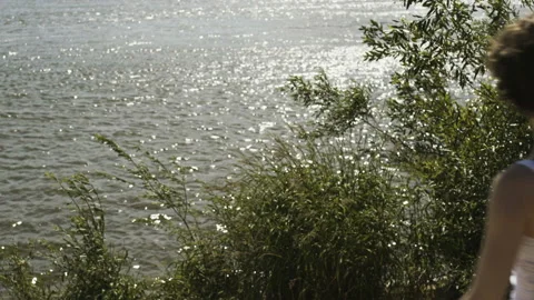 Five Young Musicians Walking Along a Wild River Stock Footage 90130738