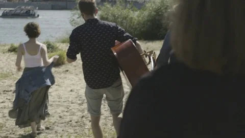 Five Young Musicians Walking to the River Bank Stock Footage 81513050