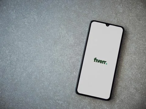 Fiverr app launch screen with logo on the display of a black mobile smartphon Stock Photos