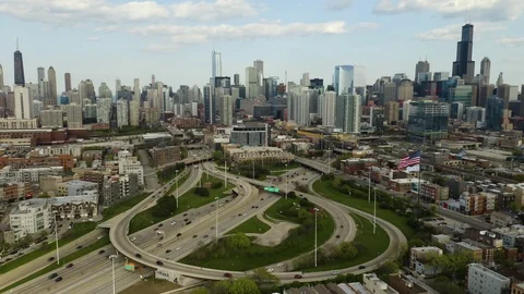 Fixed Aerial Busy Highway Interchange with City Skyline [4K] [Aerial] Stock Footage 107501407