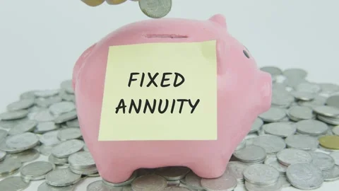 Fixed Annuity Word Or Text on Yellow Note Paper and Hand Inserting Coins Stock Footage 301506839