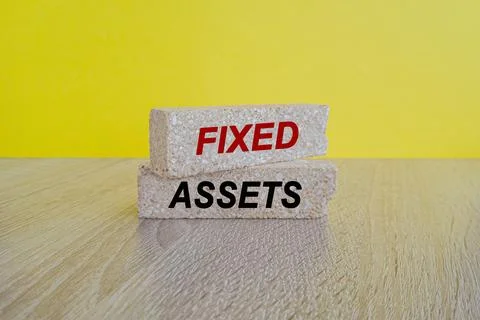 Fixed assets symbol. Concept words fixed assets on brick blocks. Stock Photos