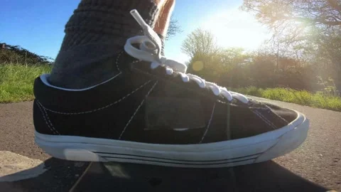 Fixed Camera Onboard Skateboard Deck Being Ridden Fast on British Sidewalk Stock Footage 239030209