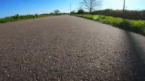 Fixed Camera Onboard Skateboard Deck Being Ridden Fast on British Sidewalk Stock Footage 239047343