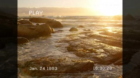 Fixed camera recording rocky shore with timecode updating and PLAY overlay waves Video stock 317369182