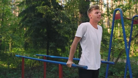 FIXED Caucasian attractive athletic man doing workout in the open-air. Stock Footage 157071209