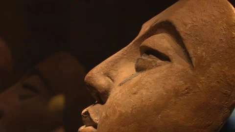Fixed close-up of the painted clay Buddha face statue in the Xixia Museum. Stock Footage 248495296
