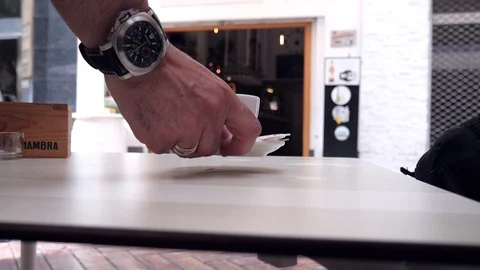 Fixed close up on a waiter putting two espresso white coffee cups on a table Stock Footage 117244603