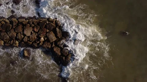 Fixed downward aerial view of end of breakwater in Mediterranean sea Stock Footage 160093450