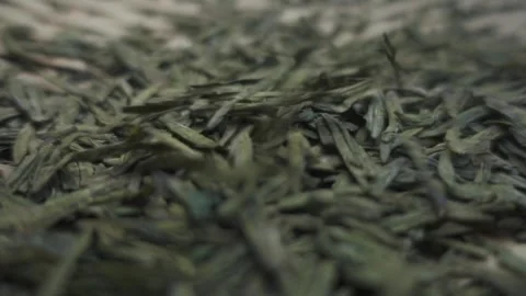 Fixed filming of tea leaves falling and pouring water into cups. Stock Footage 249046230