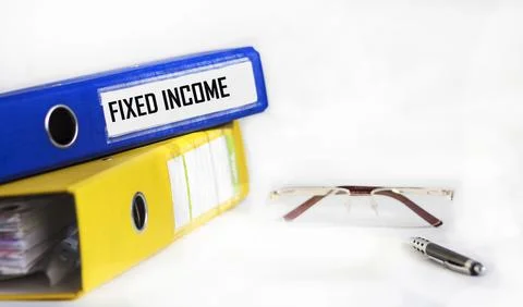 FIXED INCOME text on blue folder with pen, glasses on white background Stock Photos
