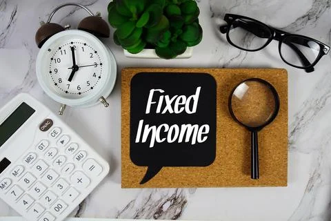 Fixed Income text on speech bubble with alarm clock, calculator and magnify.. Stock Photos