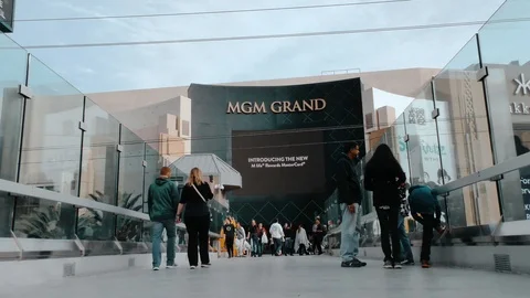 Fixed low angle shot of people walking outside an MGM Grand entrance Stock Footage 106621600