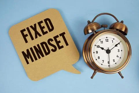 Fixed Mindset text with alarm clock on blue background Stock Photos