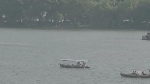 Fixed multi lens shooting of West Lake cruise ship. Video stock 253257769