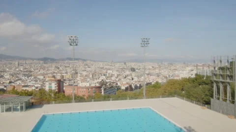 Fixed plan of a large Olympic swimming pool with city view, in Barcelona, Spain Stock Footage 221103901