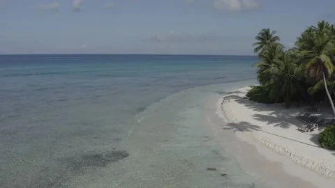 Fixed point above water to frame of a piece of the island and the Caribbean Sea Stock Footage 140825927