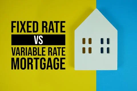 Fixed Rate Vs Variable Rate Mortgage text with house models on yellow backg.. Stock Photos