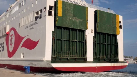 Fixed shot of the back of a ferry boat vessel leaving the dock Stock Footage 116629325
